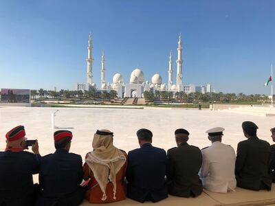 Attendees wait patiently in sight of the Grand Mosque. The National