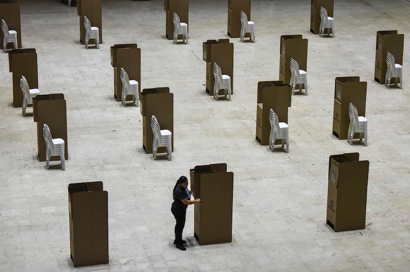 A worker assembles voting booths at a polling station in Cali, Colombia. Luis Robayo / AFP