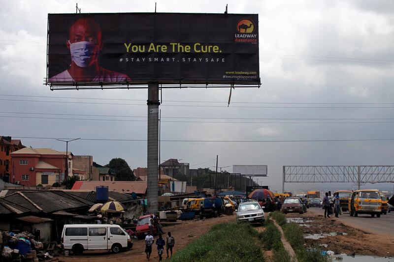 A billboard campaigning for the prevention of the coronavirus is seen standing in a neigbourhood in Lagos. EPA