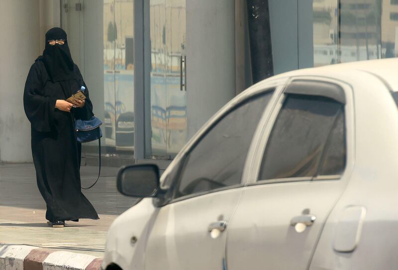 A Saudi woman walks near car down a street in the Saudi capital Riyadh on September 27, 2017.
Saudi Arabia will allow women to drive from next June, state media said on September 26, 2017 in a historic decision that makes the Gulf kingdom the last country in the world to permit women behind the wheel. 
The shock announcement comes after a years-long resistance from women's rights activists, some of whom were jailed for defying the ban on female driving. / AFP PHOTO / FAYEZ NURELDINE