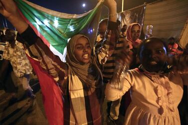 Sudanese protestors celebrate after an agreement was reached with the military council to form a three-year transition period for transferring power to a full civilian administration, in Khartoum, early on May 15, 2019. AFP