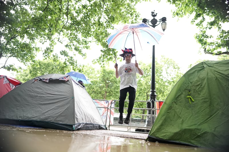 Royal superfan John Loughrey jumps for joy on The Mall, near Buckingham Palace, London, where he is already camped out for a prime position to view the platinum jubilee celebrations. PA