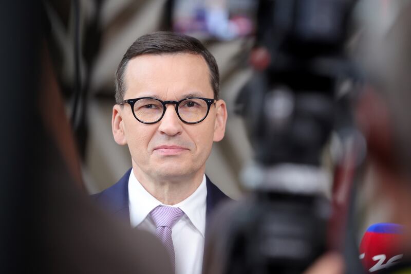 Poland's Prime Minister Mateusz Morawiecki accused EU partners of wanting the migrant-sharing deal "to be a forced process". EPA
