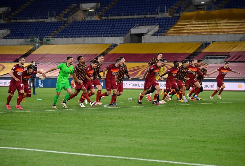 Roma players celebrate after beating Lazio. EPA
