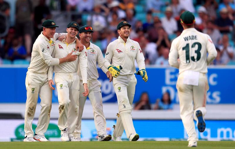 Australia’s Steve Smith, second left, celebrates after catching out England batsman Chris Woakes. PA