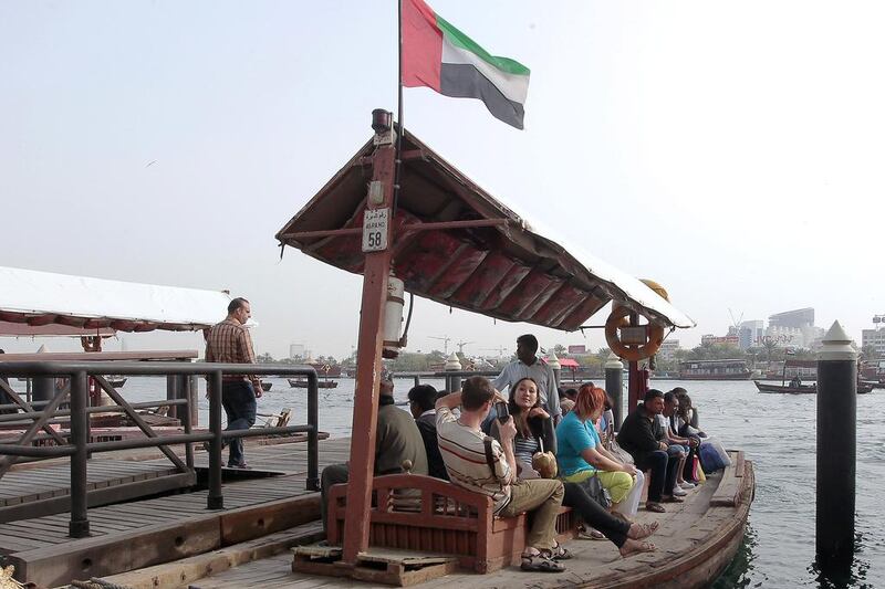 Tourists at Dubai creek as they ride on the Abra.  Jeffrey E Biteng / The National