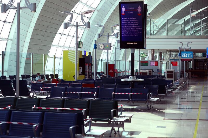 Passengers wait before boarding at Dubai International Airport on April 27, 2020. Reuters