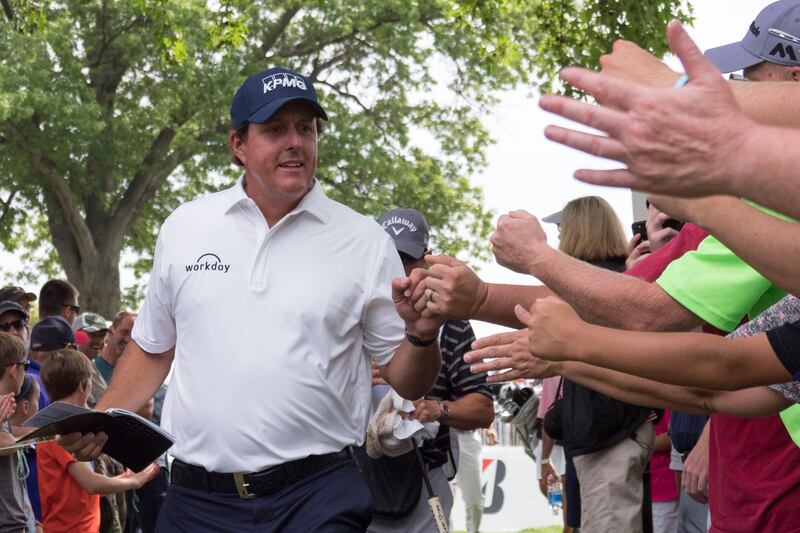 August 6, 2017; Akron, OH, USA; Phil Mickelson fist bumps patrons leaving the ninth hole during the final round of the WGC - Bridgestone Invitational golf tournament at Firestone Country Club - South Course. Mandatory Credit: Kyle Terada-USA TODAY Sports