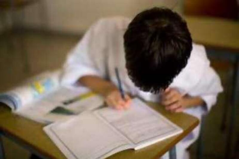 United Arab Emmirates - Abu Dhabi - Sep 24 - 2008 : A boy writes during a class at Mohamed bin Khaled School. ( Jaime Puebla / The National ) *** Local Caption ***  JP 103 - MOHAMED BIN KHALED SCHOOL.jpgJP 103 - MOHAMED BIN KHALED SCHOOL.jpg