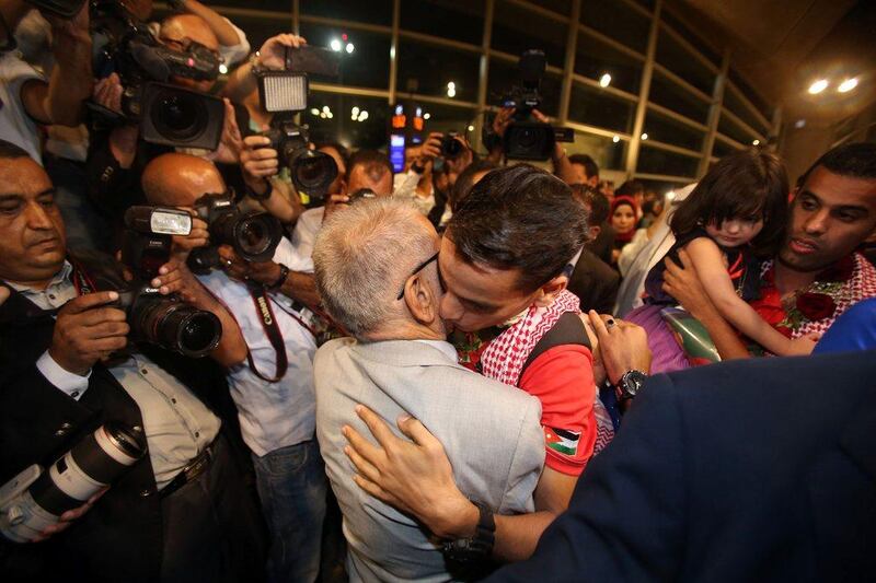 Ahmed Abughaush hugs his father. Khalil Mazraawi / AFP