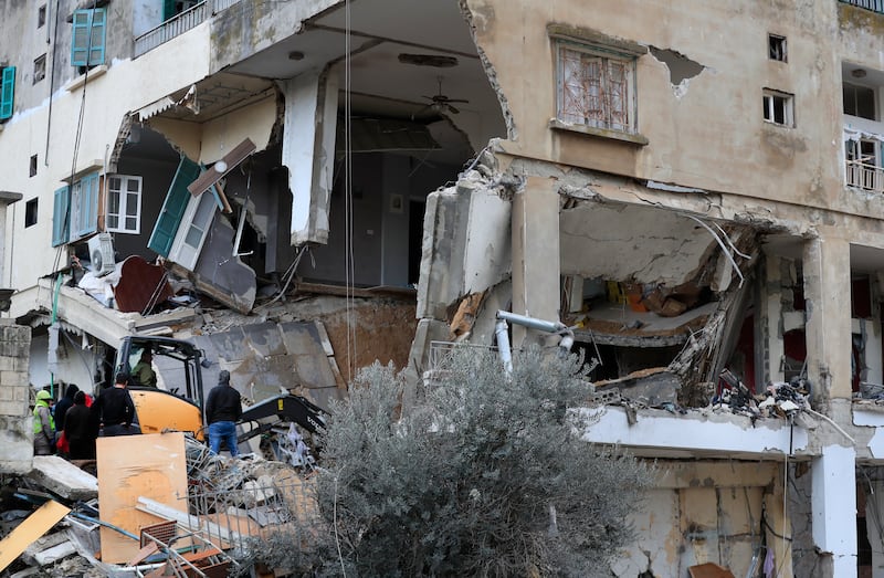 Rescue workers remove rubble from a building hit by an Israeli air strike on Wednesday, in Nabatieh, south Lebanon. AP