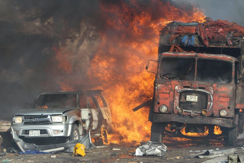 epa06265446 Vehicles burn at the scene of a massive explosion in front of Safari Hotel in the capital Mogadishu, Somalia, 14 October 2017. Reports state at least 20 peole have been killed when a truck bomb went off on a busy street in central Mogadishu. There was no immediate claim of responsibility but the country's Islamist militant group al-Shabab often carries out similar attacks in the capital.  EPA/SAID YUSUF WARSAME