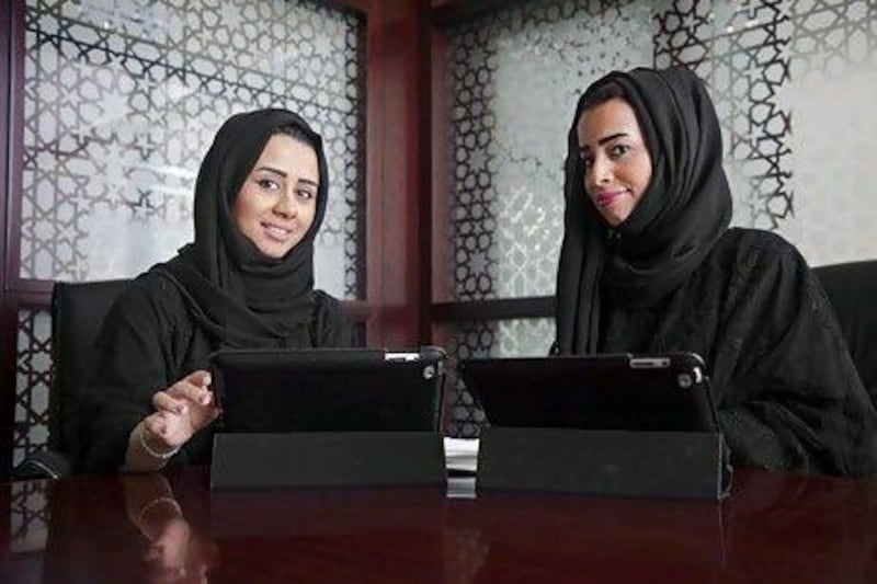 Mouza Shabeeb, left, and Eiman Al Hosani, who are colleagues at Invest AD, have teamed up to create a multi-platform initiative called Jeda Al Jiouin.  The young executives hope their idea will help Emirati businesswomen to become more competitive on a local and global level. Lee Hoagland / The National