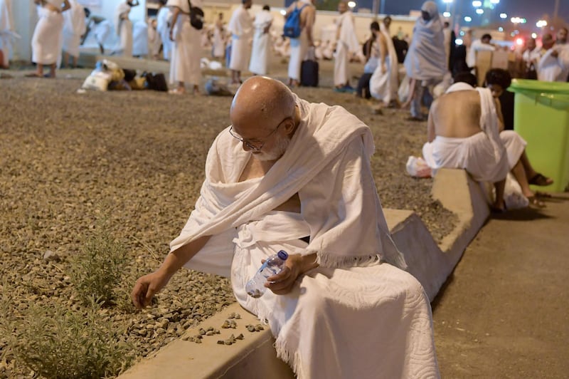 A Muslim pilgrim collects pebbles at Muzdalifah near the holy city of Makkah.  AFP