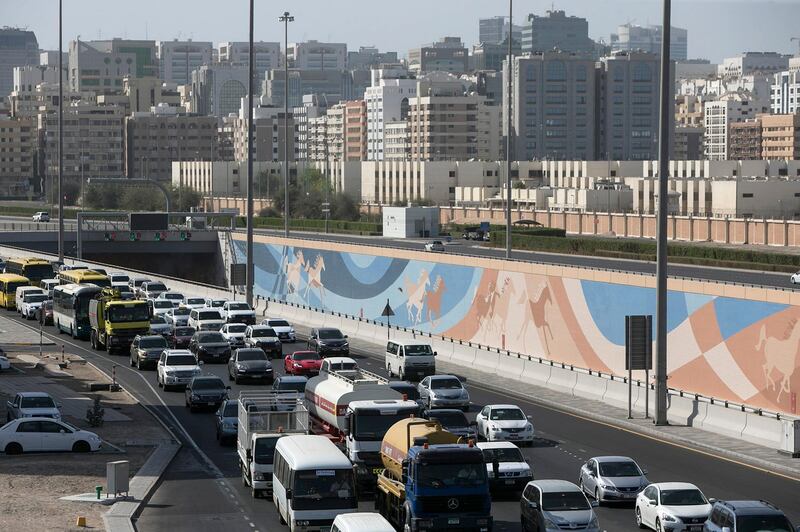 ABU DHABI, UNITED ARAB EMIRATES, May 13, 2015:  
Cars line up in thickening traffic during the beginning of rush hour on Wednesday, May 13, 2015, at an exit near the Sheikh Zayed road and the Sheikh Zayed tunnel in Abu Dhabi. A recent yougov survey-it says commute times in Abu Dhabi are down, and drivers are happier, but the roads still have a lot of inattentive drivers. (Silvia Razgova / The National)  (Usage: May 13, 2015, Section: NA, Reporter: ) *** Local Caption ***  SR-150513-traffic09.jpg