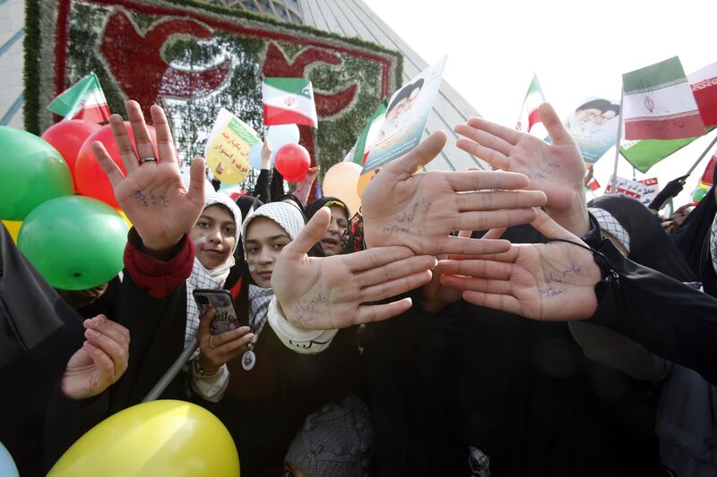 Iranian girls show their hands written in Persian, "Ready to sacrifice my life for the leader". EPA 
