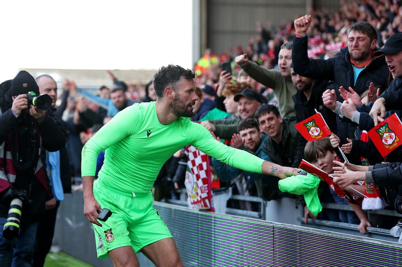 Wrexham goalkeeper Ben Foster gives his shirt to a fan after their side's victor. Getty Images