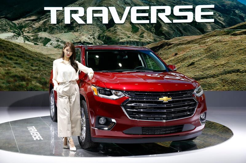 A model poses next to the Chevrolet Traverse at the show. EPA
