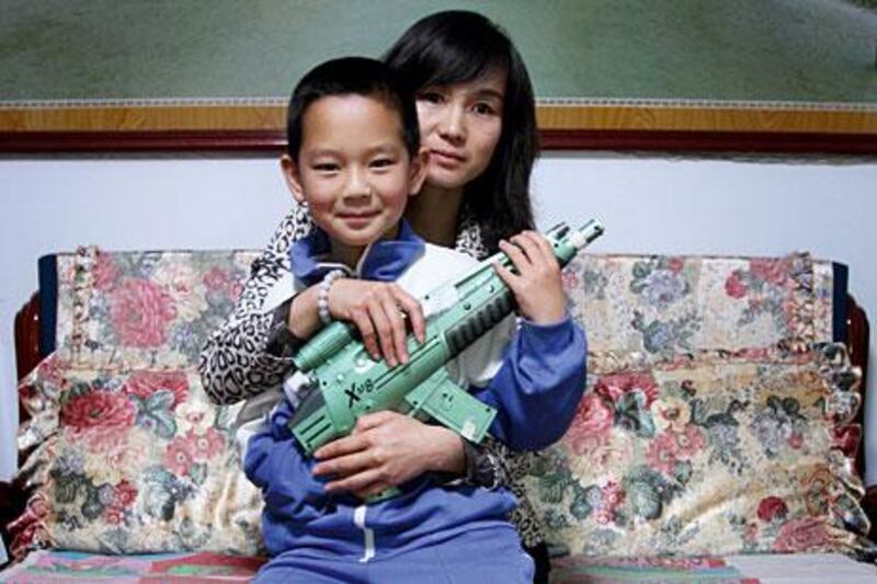 Zhang Wenyan shares a tender moment with her son, Li Zeyuan, age 12, at their home in Beijing.