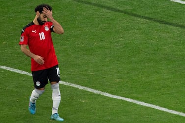 Egypt's Mohamed Salah, left, reacts after failing to score his penalty kick against Senegal's goalkeeper Edouard Mendy during the World Cup 2022 - Africa playoff soccer match between Senegal and Egypt at at Stade Me Abdoulaye Wade stadium in Dakar, Senegal, Tuesday, March 29, 2022.  (AP Photo / Stefan Kleinowitz)