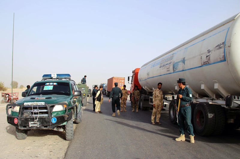 Security officials check vehicles on a road side in Helmand. EPA