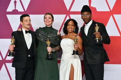 FILE - This Feb. 24, 2019 file photo shows Oscar winners, from left, Rami Malek, for best performance by an actor in a leading role for "Bohemian Rhapsody", Olivia Colman, for best performance by an actress in a leading role for "The Favourite", Regina King, for best performance by an actress in a supporting role for "If Beale Street Could Talk", and Mahershala Ali, for best performance by an actor in a supporting role for "Green Book", holding their awards in the press room at the Oscars in Los Angeles. The four will present awards during the Feb. 9 ceremony. (Photo by Jordan Strauss/Invision/AP, File)