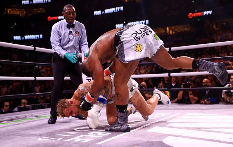 Tyron Woodley throws Jake Paul to the canvas. AFP