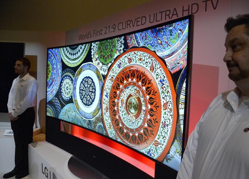 The world's first curved television, the LG Curved Ultra 108 inch HD TV is guarded by LG employees after being unveiled at the Consumer Electronics Show in Las Vegas. EPA/MICHAEL NELSON