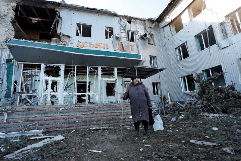 A woman stands outside a local hospital, damaged during fighting in Volnovakha. Reuters