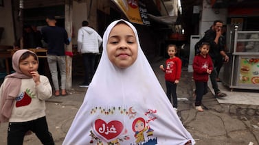 A Palestinian child shows off her special clothes before Eid Al Fitr celebrations in Rafah. The end of Ramadan is a special time for Muslims, but the continuing catastrophe of Gaza will be foremost in many people’s minds. AFP