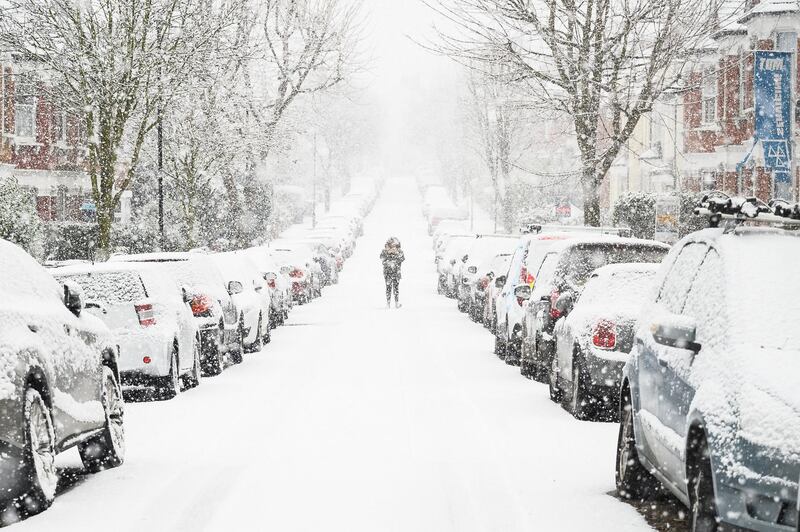 A man wearing a face mask walks through the snow in Muswell Hill in London, United Kingdom. Parts of the country saw snow and icy conditions as arctic air caused temperatures to drop. Getty Images