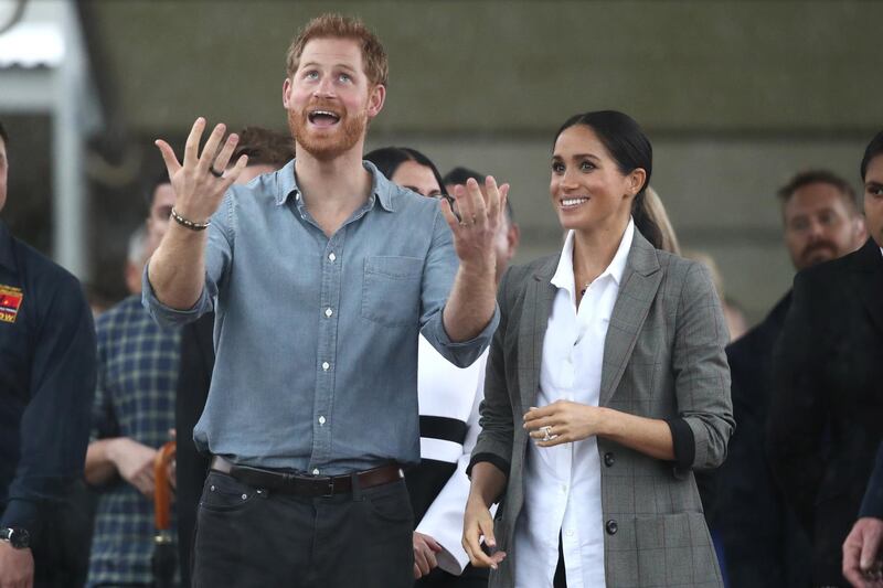 Prince Harry and Meghan react as they look out towards the heavy rain and storm as they visit the Clontarf Foundation and Girls Academy at Dubbo College on October 17, 2018 in Dubbo, Australia. Getty Images