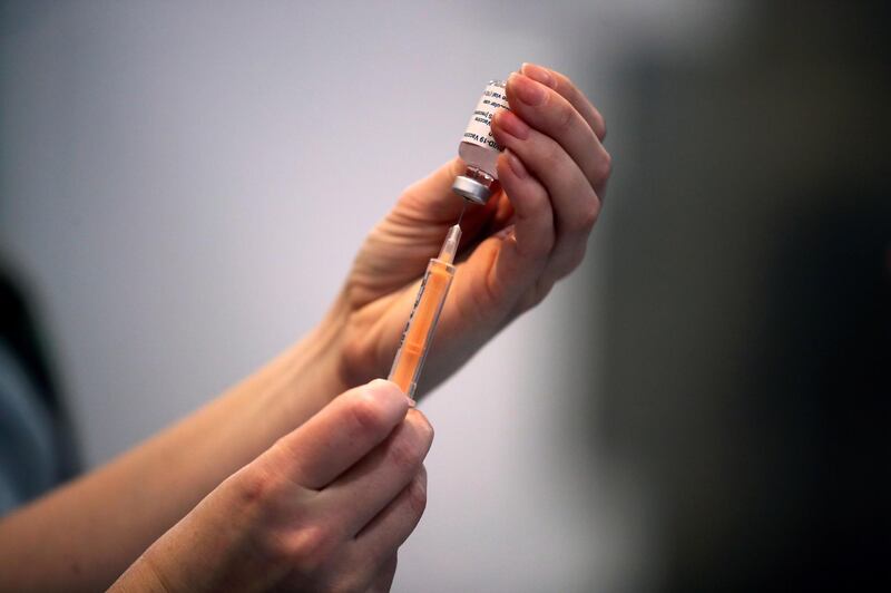 FILE PHOTO: A healthcare worker prepares a dose of the coronavirus disease (COVID-19) vaccine at a vaccination centre inside the Blackburn Cathedral, in Blackburn, Britain, January 19, 2021. REUTERS/Molly Darlington/File Photo