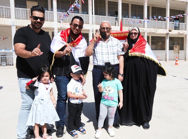 People show their ink-stained fingers after casting their votes in Najaf. Photo: Reuters