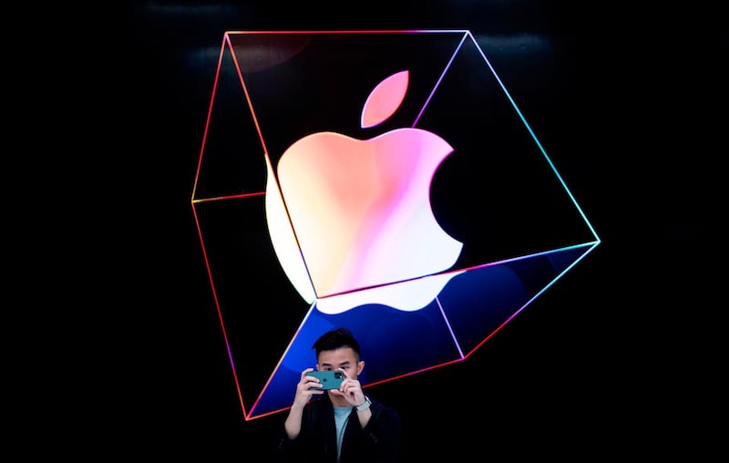 A man takes a picture with a new iPhone 11 inside the newly renovated Apple Store at Fifth Avenue in New York City. AFP