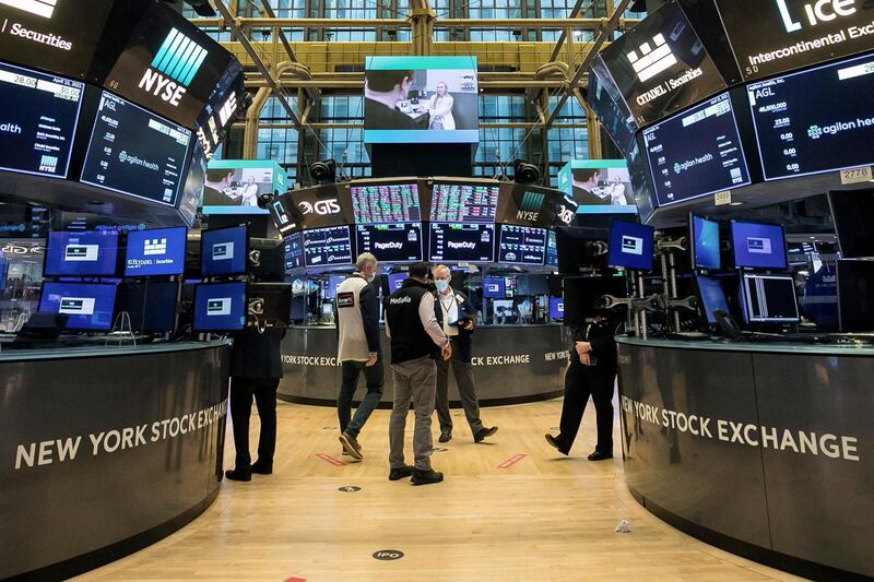 In this photo provided by the New York Stock Exchange, traders work on the floor, Thursday, April 15, 2021. U.S. stocks are rallying toward records on Thursday after a suite of encouraging data showed how hungry Americans are to spend again, how fewer workers are losing their jobs and how much fatter corporate profits are getting. (Courtney Crow/New York Stock Exchange via AP)