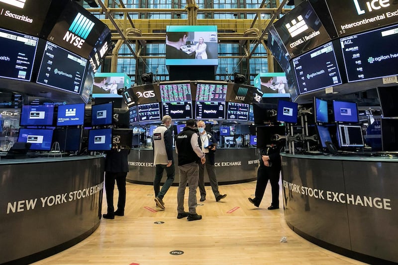 In this photo provided by the New York Stock Exchange, traders work on the floor, Thursday, April 15, 2021. U.S. stocks are rallying toward records on Thursday after a suite of encouraging data showed how hungry Americans are to spend again, how fewer workers are losing their jobs and how much fatter corporate profits are getting. (Courtney Crow/New York Stock Exchange via AP)