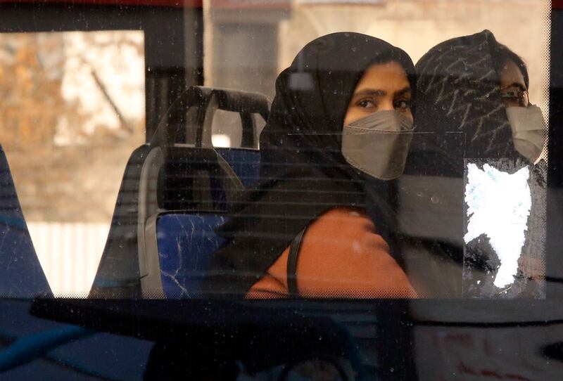 Women travel on a bus in Tehran, Iran. Coronavirus infections have surged in the country in recent weeks. Photo: EPA