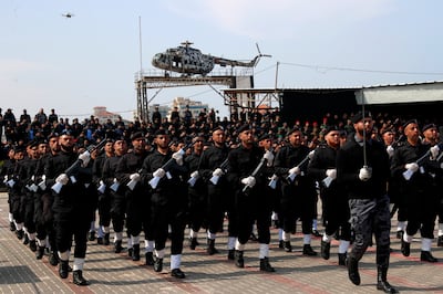 Members of the Hamas security forces march with mock wooden rifles as a drone flies overhead, during a graduation ceremony in Gaza City, on Monday. AP Photo