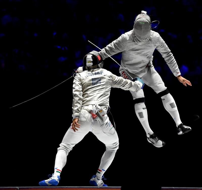Aron Szilagyi, left, of Hungary fights against Sanguk Oh of the South Korea in the men's team sabre final of the FIE World Fencing Championships in Budapest, Hungary. South Korea won the gold.  AP