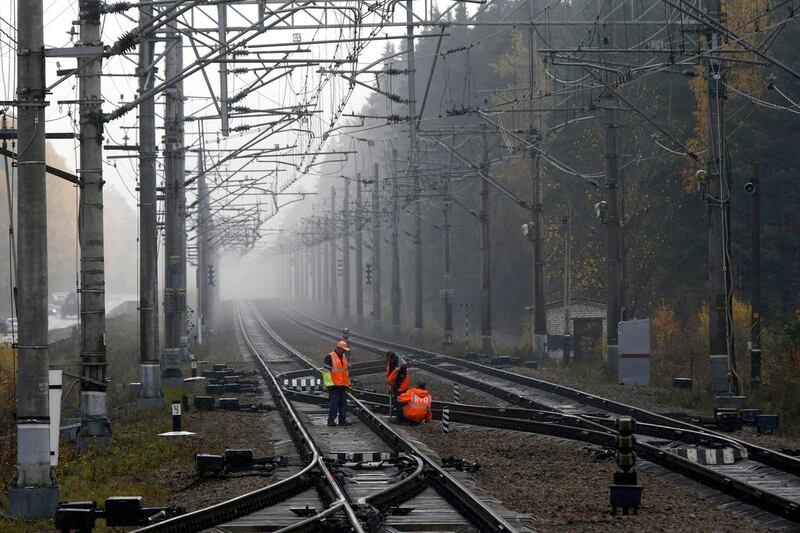 Workers in Kannelyarvi inspect the new high speed rail link to Finland. Alexander Demianchuk / Reuters