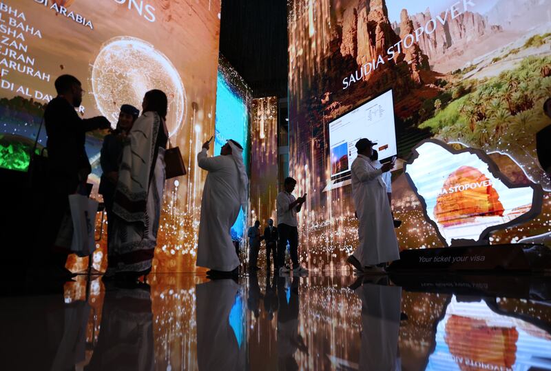 Visitors inspect the Saudi stand during Arabian Travel Market in Dubai. The kingdom is focusing on growing its tourism sector to diversify its economy from oil. EPA