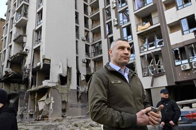 Kyiv's mayor Vitali Klitschko stands in front of a damaged building following Russian strikes in the capital. AFP 