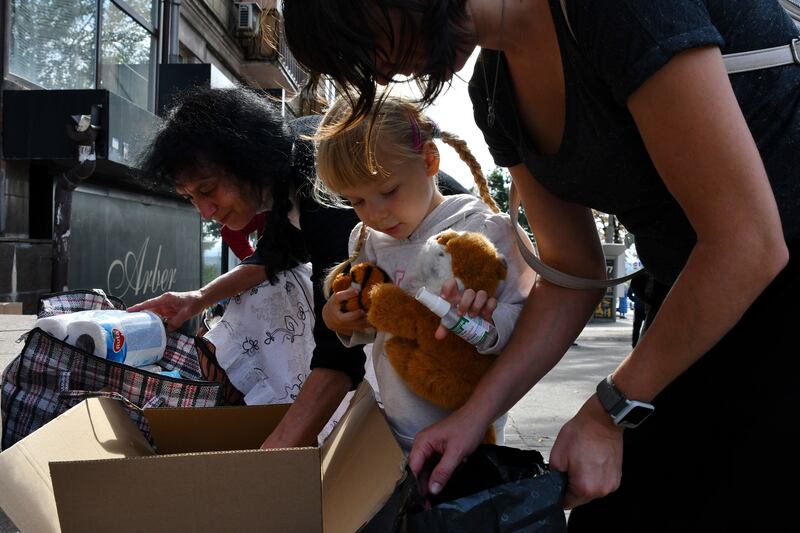 Refugees from eastern Ukraine receive humanitarian aid. AP