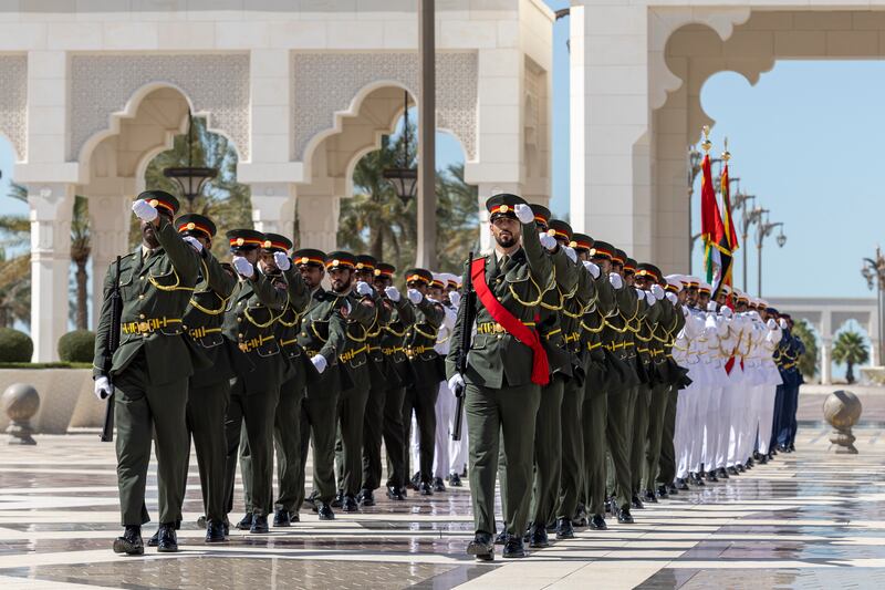 Members of the honour guard march in formation during the visit of Mr Al Sudani, who led a delegation of senior Iraqi officials.