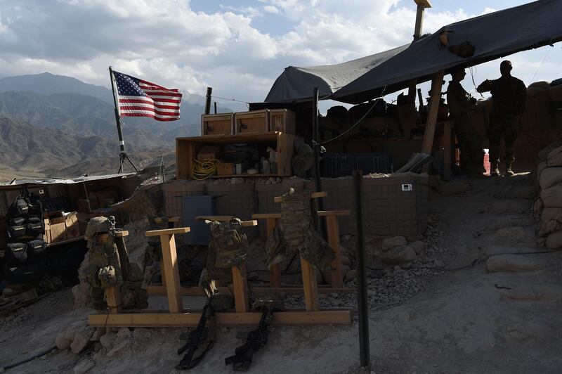 (FILES) In this file photo taken on July 7, 2018 In this photo taken on July 7, 2018, US Army soldiers from NATO looks on as US flag flies in a checkpoint during a patrol against Islamic State militants at the Deh Bala district in the eastern province of Nangarhar Province. Two US service members were killed on March 22, 2019 while conducting an operation, according to a statement released by the US and NATO Resolute Support mission. / AFP / WAKIL KOHSAR
