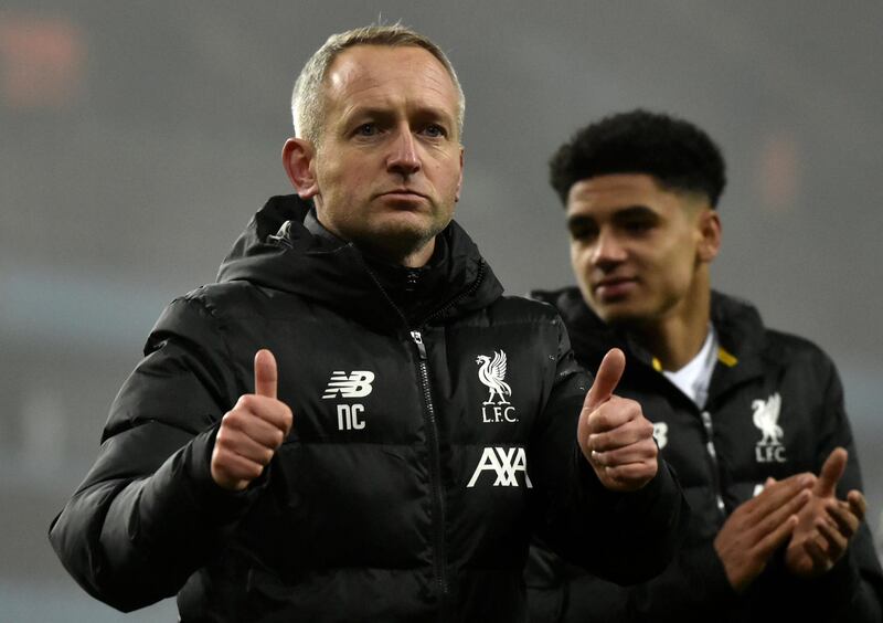 Liverpool's Under 23 coach Neil Critchley, left, leaves the field at the end of the game. AP