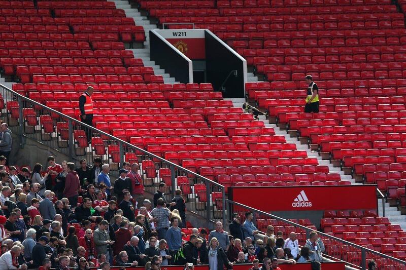 A sniffer dog patrols the stands after fans were evacuated from the ground prior to the Premier League match between Manchester United and AFC Bournemouth at Old Trafford on May 15, 2016 in Manchester, England. (Alex Morton/Getty Images)