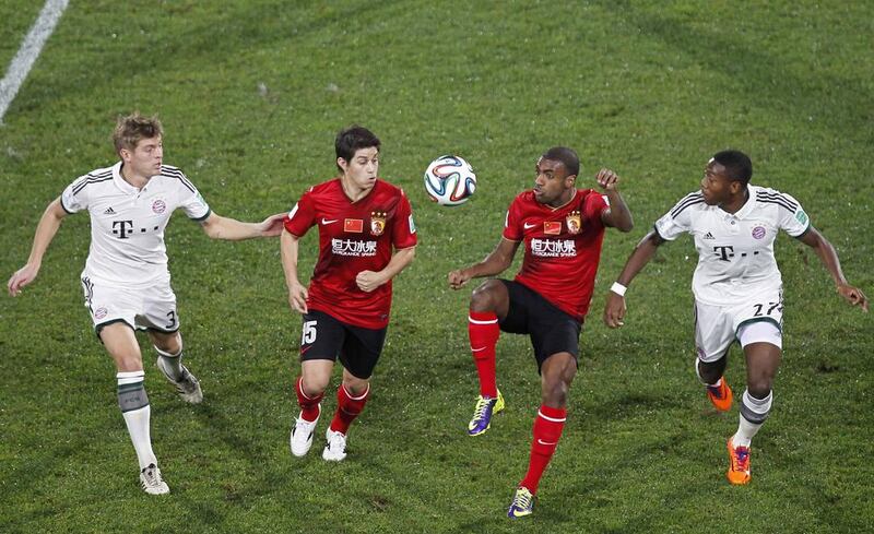 Guangzhou Evergrande’s Muriqui, second right, and Dario Conca, second left, fight for the ball with Bayern Munich’s David Alaba, right, and Toni Kroos during their Club World Cup match at Agadir Stadium on Tuesday. Louafi Larbi / Reuters

