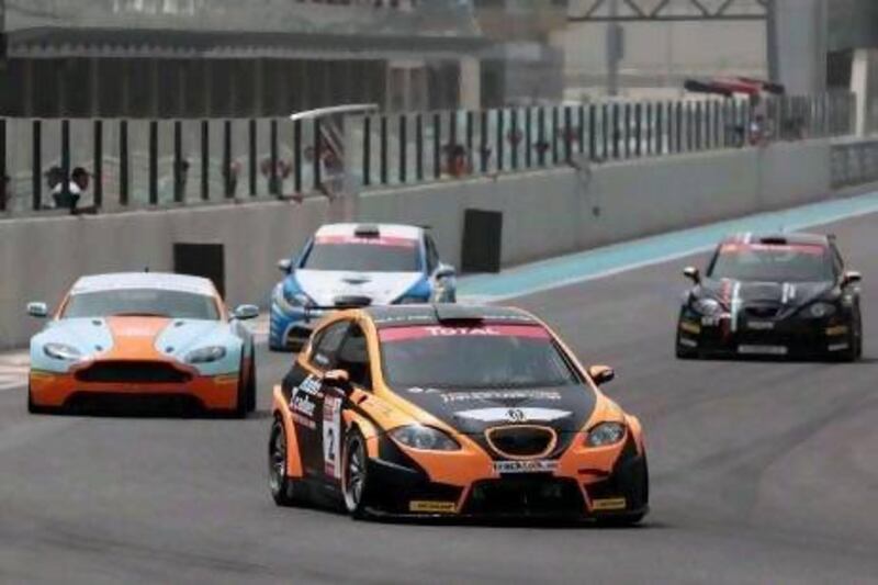 Nader Zuhour, in the orange-and-black SEAT, extended the title chase in Class 1 Total UAE Touring Cars by winning both races at the Yas Marina Circuit.